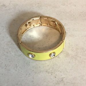 Yellow enamel stretch cuff bangle bracelet with gold trim/bling inserts.
